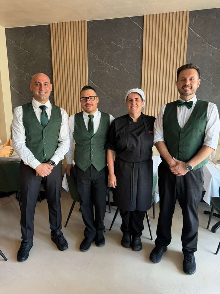 Barolo hospitality team — servers and executive chef smiling in the dining room